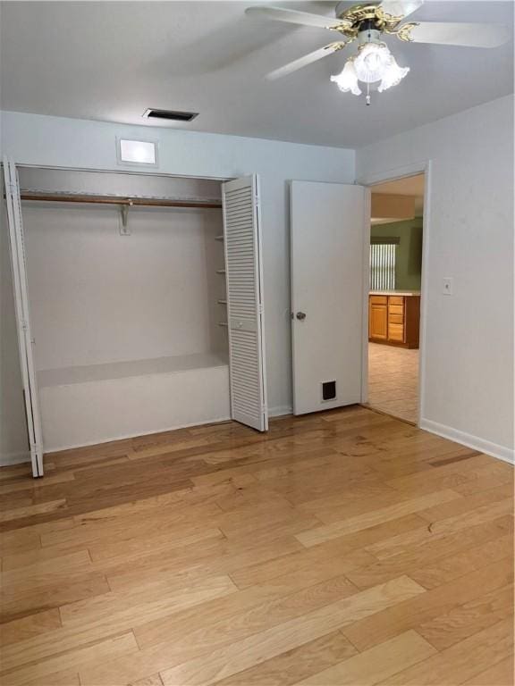 2525 84th Ter, Vero Beach, FL 32966 - unfurnished bedroom with a closet, light wood-type flooring, and a ceiling fan