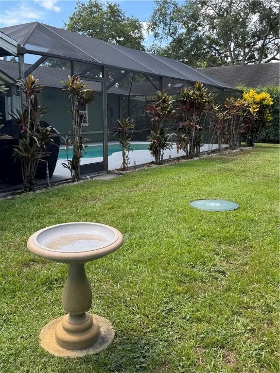 2525 84th Ter, Vero Beach, FL 32966 - view of green lawn with an outdoor pool and glass enclosure