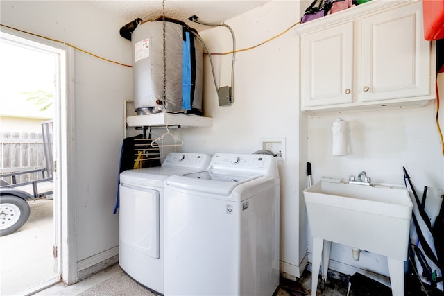 clothes washing area with sink, cabinets, and independent washer and dryer