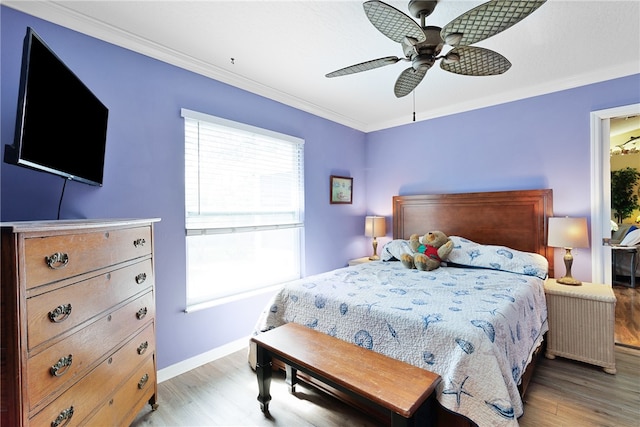 bedroom with ceiling fan, crown molding, and light hardwood / wood-style floors