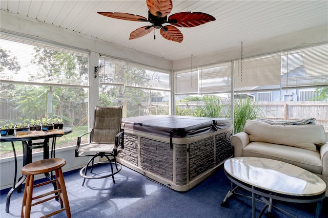 sunroom / solarium with ceiling fan and wooden ceiling