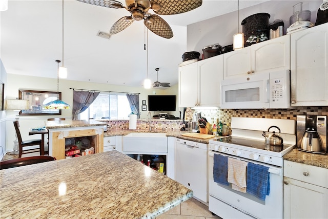 kitchen with white cabinetry, sink, decorative light fixtures, and white appliances