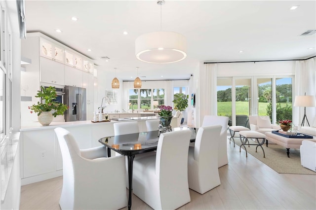 dining space featuring a wealth of natural light and light hardwood / wood-style flooring