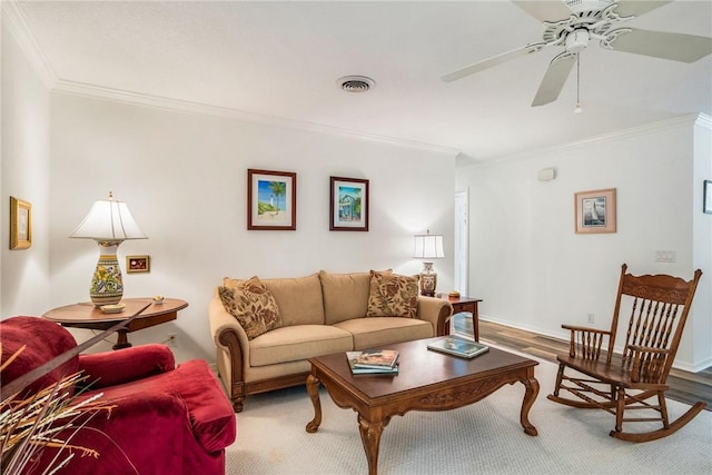 living room with hardwood / wood-style floors, ceiling fan, and crown molding