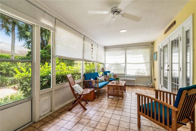 sunroom / solarium featuring ceiling fan