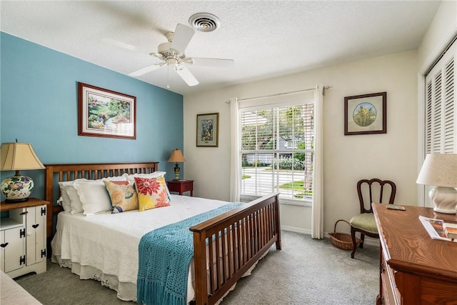 bedroom with light carpet, a textured ceiling, a closet, and ceiling fan