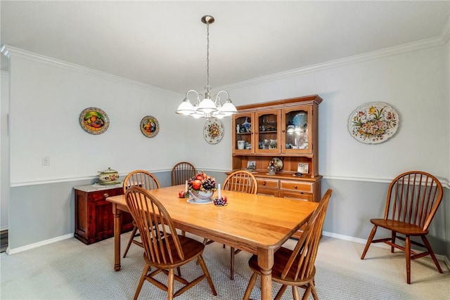 carpeted dining area featuring a chandelier and crown molding