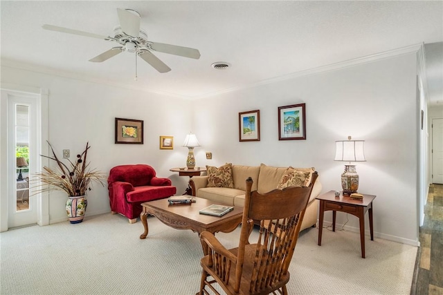 living room featuring ceiling fan, carpet floors, and crown molding