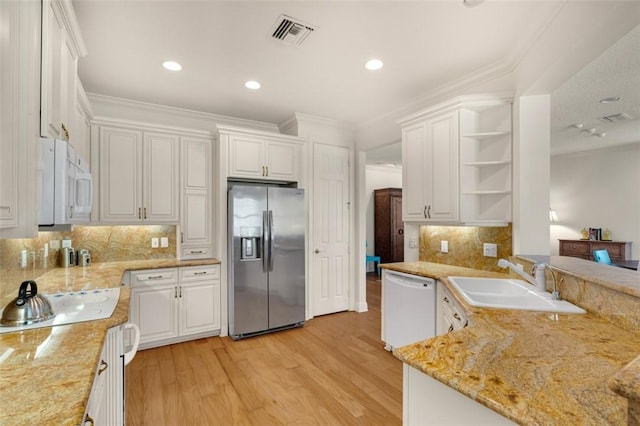 kitchen with visible vents, white appliances, open shelves, and a sink