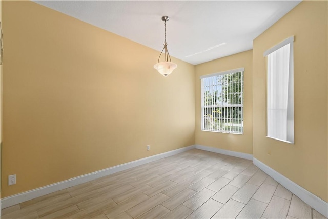 8365 104th Ct, Vero Beach, FL 32967 - spare room with baseboards and wood tiled floors