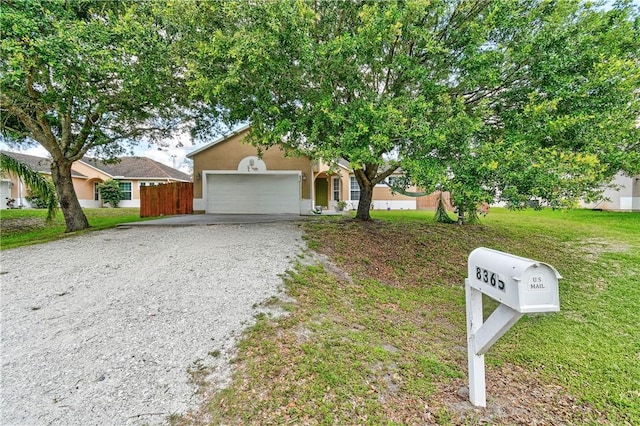8365 104th Ct, Vero Beach, FL 32967 - view of front of property with driveway, an attached garage, stucco siding, and a front lawn