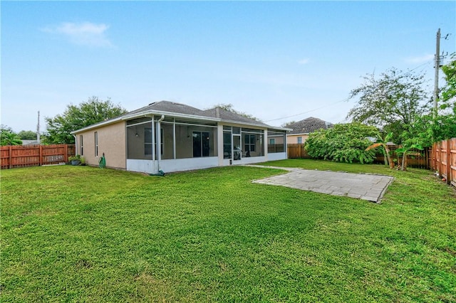 8365 104th Ct, Vero Beach, FL 32967 - rear view of house featuring a sunroom, a fenced backyard, and a patio area