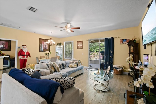 8365 104th Ct, Vero Beach, FL 32967 - living room featuring wood finished floors, ceiling fan, and a chandelier