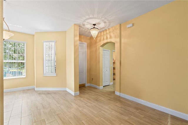 8365 104th Ct, Vero Beach, FL 32967 - unfurnished room featuring arched walkways and light wood finished floors
