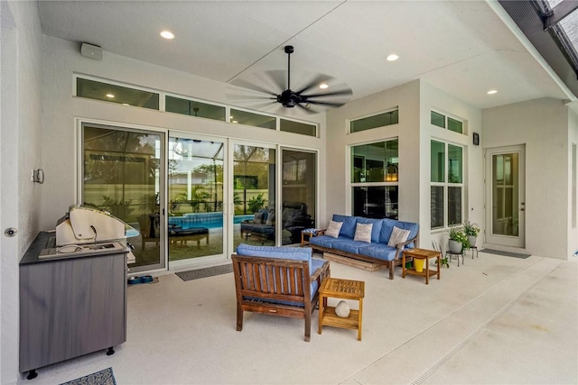 view of patio featuring outdoor lounge area, ceiling fan, and an outdoor pool