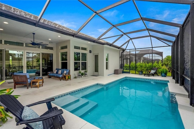 outdoor pool with outdoor lounge area, a ceiling fan, a patio area, and a lanai