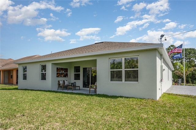 502 Saunders St, Sebastian, FL 32958 - back of house featuring stucco siding, a patio area, and a lawn