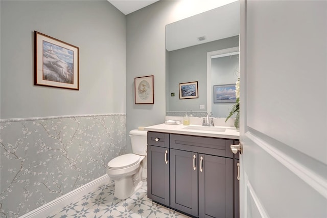 8280 Halbert Ln, Vero Beach, FL 32968 - bathroom with toilet, vanity, tile patterned floors, and baseboards