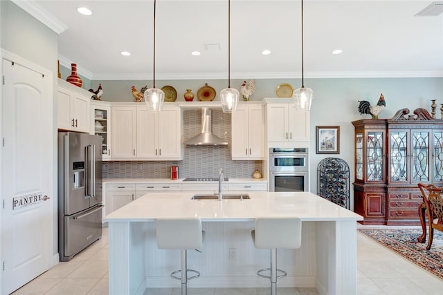 8280 Halbert Ln, Vero Beach, FL 32968 - kitchen with appliances with stainless steel finishes, wall chimney exhaust hood, tasteful backsplash, a sink, and a kitchen bar