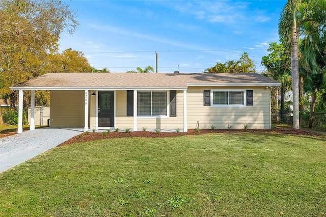 ranch-style house featuring a front yard and a carport