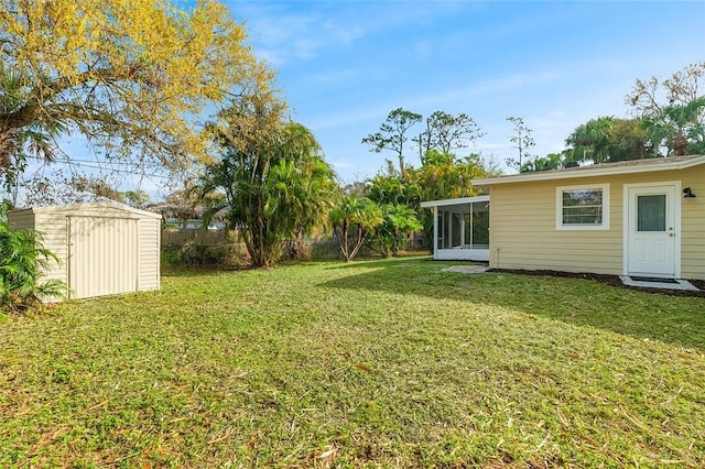 view of yard with a shed and a sunroom