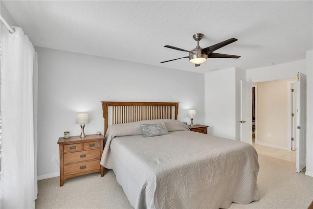 bedroom featuring light carpet and ceiling fan