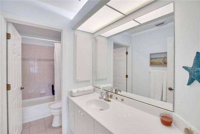 full bathroom featuring toilet, vanity, tile patterned flooring, and shower / bath combo