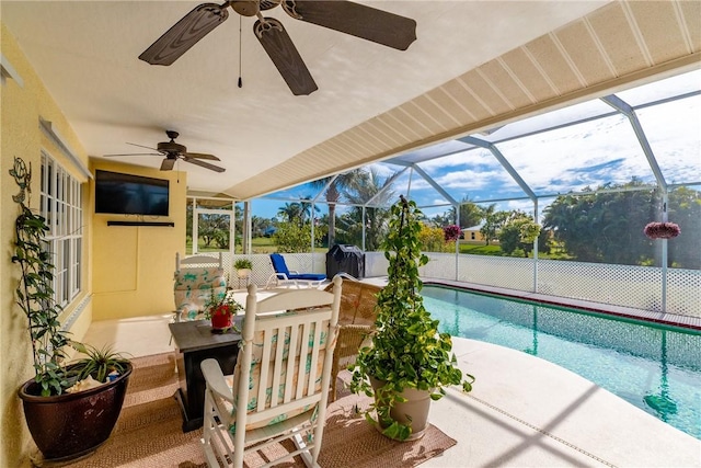 view of swimming pool with a patio area, a lanai, and ceiling fan