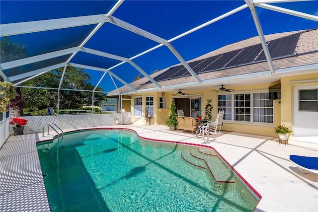 view of pool featuring a lanai, ceiling fan, and a patio