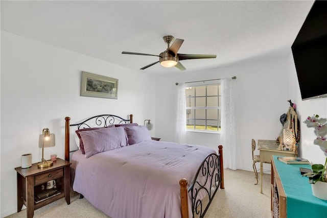 bedroom with ceiling fan and light colored carpet