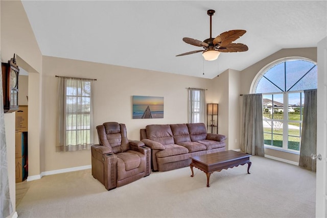 carpeted living room with vaulted ceiling and ceiling fan