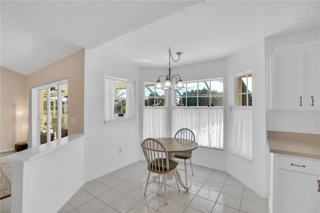 dining space with an inviting chandelier and light tile patterned floors