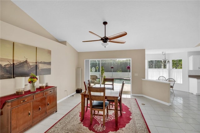 tiled dining space with ceiling fan and vaulted ceiling