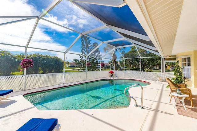 view of swimming pool featuring glass enclosure and a patio