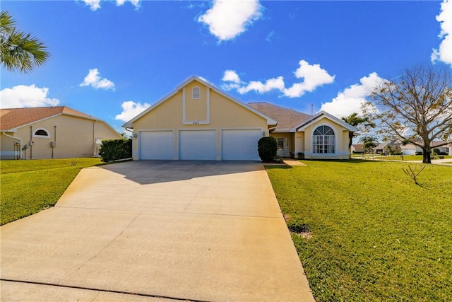 view of front of property with a garage and a front lawn