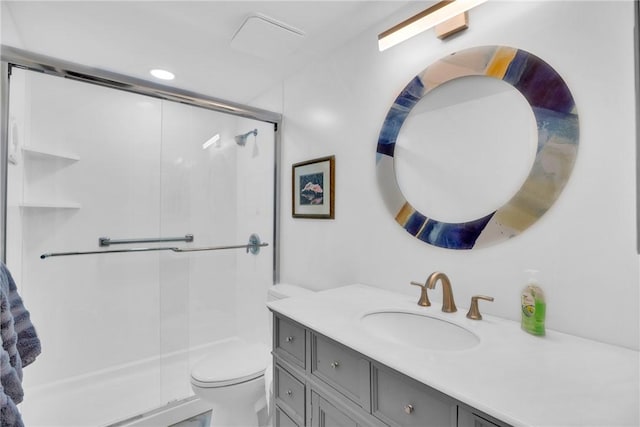 bathroom featuring vanity, an enclosed shower, and toilet