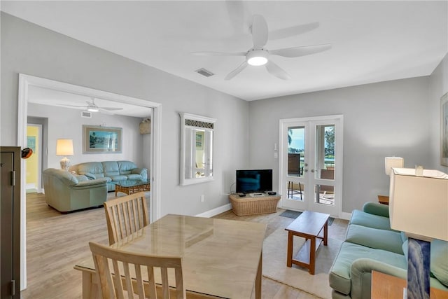 living room with light hardwood / wood-style flooring, french doors, and ceiling fan