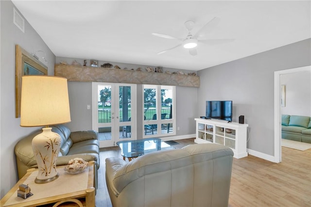 living room with ceiling fan and light hardwood / wood-style floors