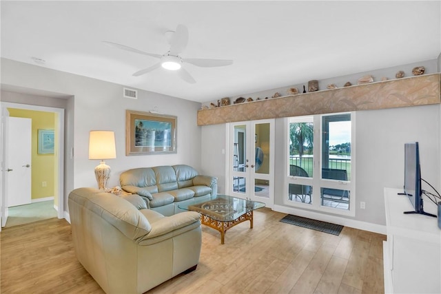 living room featuring ceiling fan and light wood-type flooring