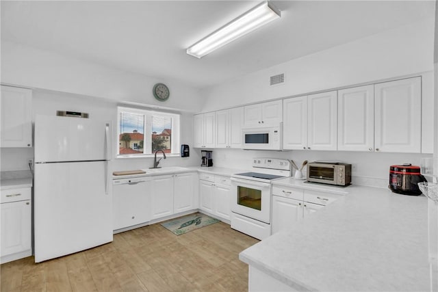 kitchen featuring white cabinetry, white appliances, light hardwood / wood-style floors, and sink