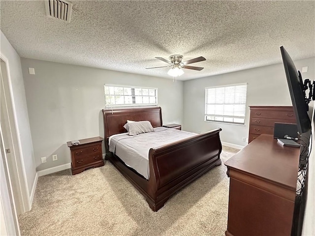 2890 1st Pl, Vero Beach, FL 32968 - bedroom featuring baseboards, a textured ceiling, light carpet, and a ceiling fan