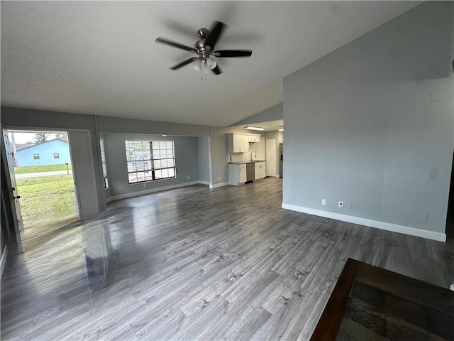 2890 1st Pl, Vero Beach, FL 32968 - unfurnished living room featuring ceiling fan, baseboards, lofted ceiling, wood finished floors, and a sink