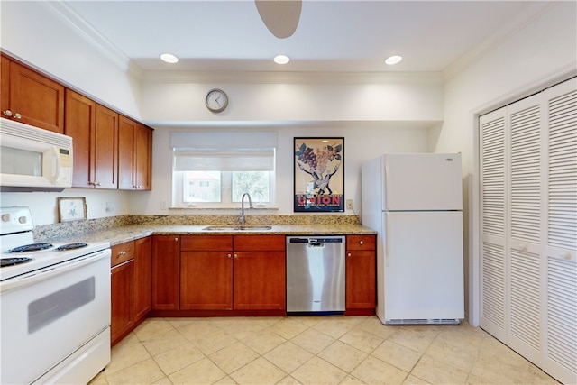 kitchen featuring sink, light stone counters, white appliances, and crown molding