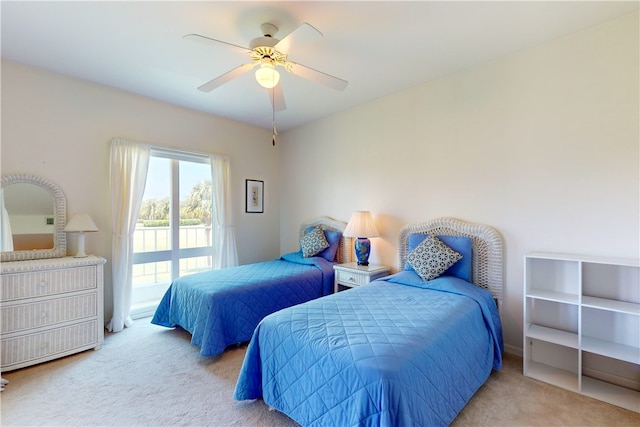 bedroom with ceiling fan and light carpet