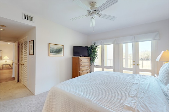 bedroom with french doors, access to exterior, a closet, ceiling fan, and light colored carpet