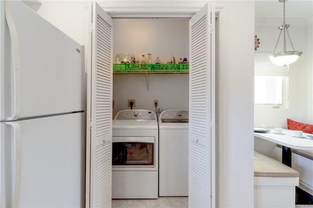 clothes washing area featuring independent washer and dryer