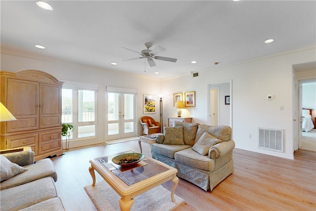 living room featuring ornamental molding, ceiling fan, french doors, and light hardwood / wood-style floors