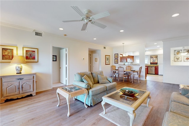 living room with light hardwood / wood-style floors, crown molding, and ceiling fan with notable chandelier