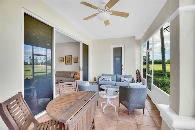 sunroom / solarium featuring a ceiling fan