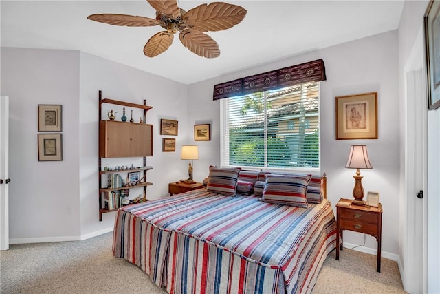 bedroom with light carpet, ceiling fan, and baseboards